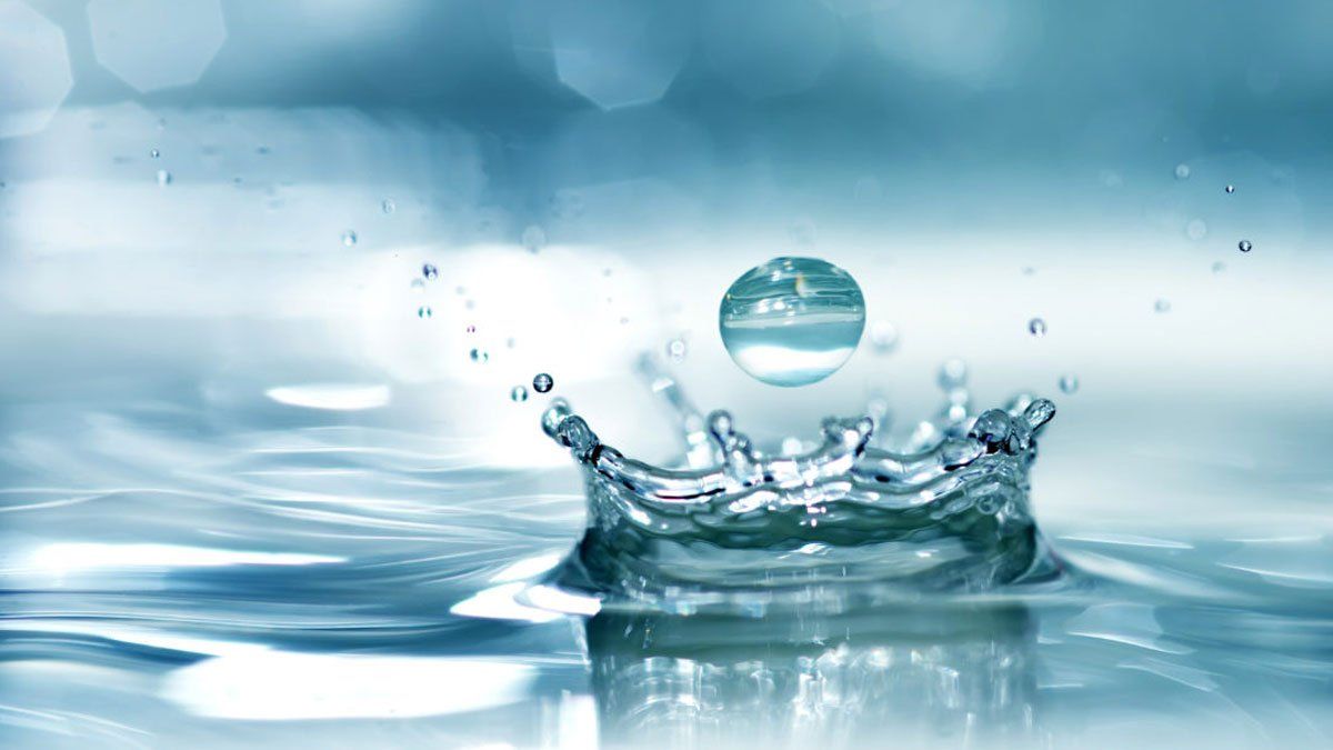 water droplet landing in pool of water